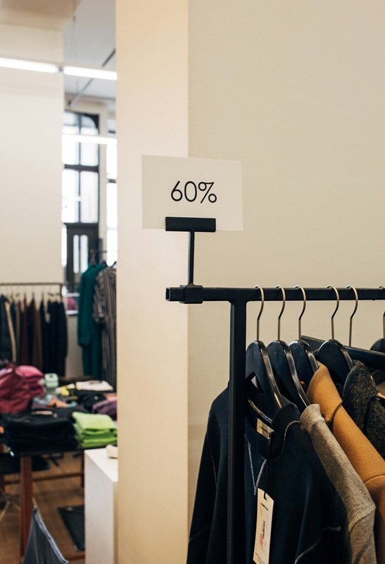 Clearance sale rack in a clothing store — cutting back on shopping to save money